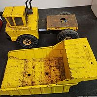 Side view showing cab, wheels and detached dump bed