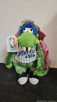Front view of Stuff mascot plush showing jersey, sneakers and hang tag