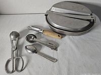 all items laid out: mess kit closed, utensils alongside