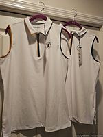 Two white sleeveless Walter Hagen polo shirts on hangers