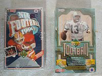 Both sealed Upper Deck football card boxes side by side