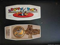 Closed and open Looney Tunes presentation case with pocket watch and chain inside