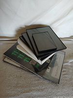 Stack of eight assorted frames showing range of sizes and colors