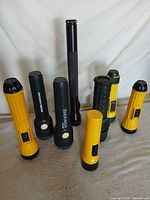 Group shot of all eight flashlights upright
