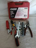 Closed red OEM case with loose tools arranged in front