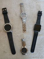 All four watches laid out showing overall lot contents