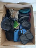 Box containing assorted phone pouches and cases
