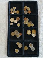 Overview of all assorted coins and tokens in display tray