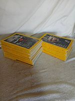 Two stacks of yellow-border National Geographic magazines on tabletop