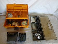 Overall lot showing tackle box, Daiwa rod in case, Bushnell binocular