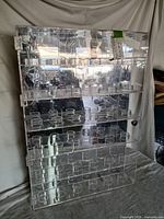 Full view of clear acrylic baseball display case showing shelves and ball holders