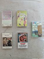 Group image of all five cassette tapes in cases