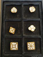 All six gold-tone mother-of-pearl pieces displayed in tray compartments