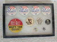 Front view of display case showing all nine pinback buttons