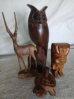 Group shot showing all four wooden carvings