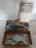 Open box with sprues, instruction sheet, and lid visible