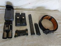 Group shot of binoculars, pouches, magazines and holder