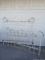 Headboard and footboard leaning against garage door