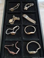 Tray showing all eight vintage wristwatches