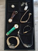 Overview of eight vintage watches in tray