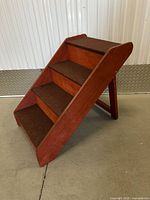 Overall view of wooden four-step carpeted pet stairs