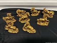 Eight gold resin horse figurines grouped