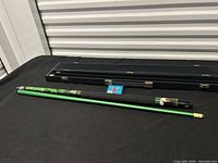 Full view of cue assembled beside closed hard case