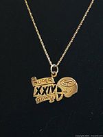 Front view of pendant on chain showing SUPER BOWL XXIV and 49ers helmet design