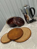 Bean pot, percolator, three wooden discs overview