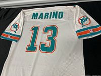 Back view showing MARINO name, number 13, Dolphins patch, Champion logo