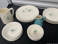Full set showing pitcher, creamer, plates and bowls