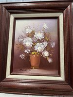 Full view of signed floral oil painting in frame