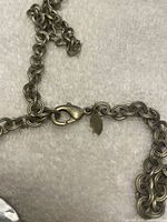 Lobster clasp and Chico’s leaf tag on chain