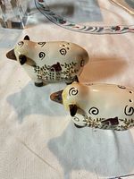 Both sheep-shaped shakers angled side view