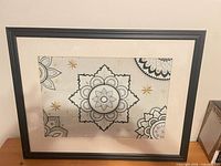 Front view of framed mandala cross-stitch art