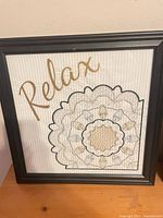 Front view of framed Relax cross-stitch artwork