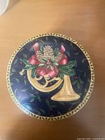 Lid showing French horn and holly design