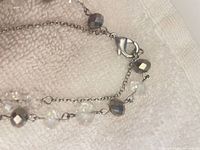 Close-up of lobster clasp, chain links and bead details