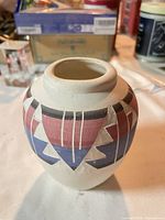 Front view of painted earthenware vase showing geometric design
