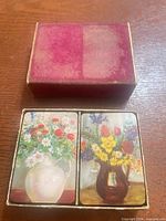 Top view of open slipcase showing two stacks of floral-back cards