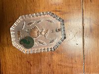 Front of crystal ornament showing etched design, year, and foil sticker