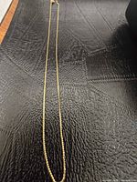 Entire length of yellow gold chain laid flat