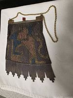 Full view of antique painted chainmail purse showing frame, chain handle and fringe