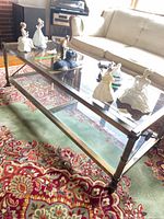 Full view of coffee table with glass top and shelf