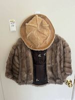 Front view of fur shawl and faux fur hat hanging