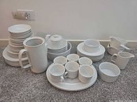Entire Johnson Bros Athena dinnerware set grouped together on floor
