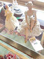 Front view of Royal Worcester “First Dance” figurine standing beside another figurine