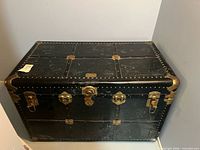 Full view of closed black Stalwart trunk showing size and hardware