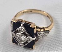 yellow gold ring with black onyx panel and diamond accents