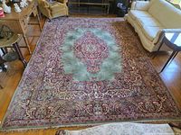 Full view of Persian wool rug on hardwood floor